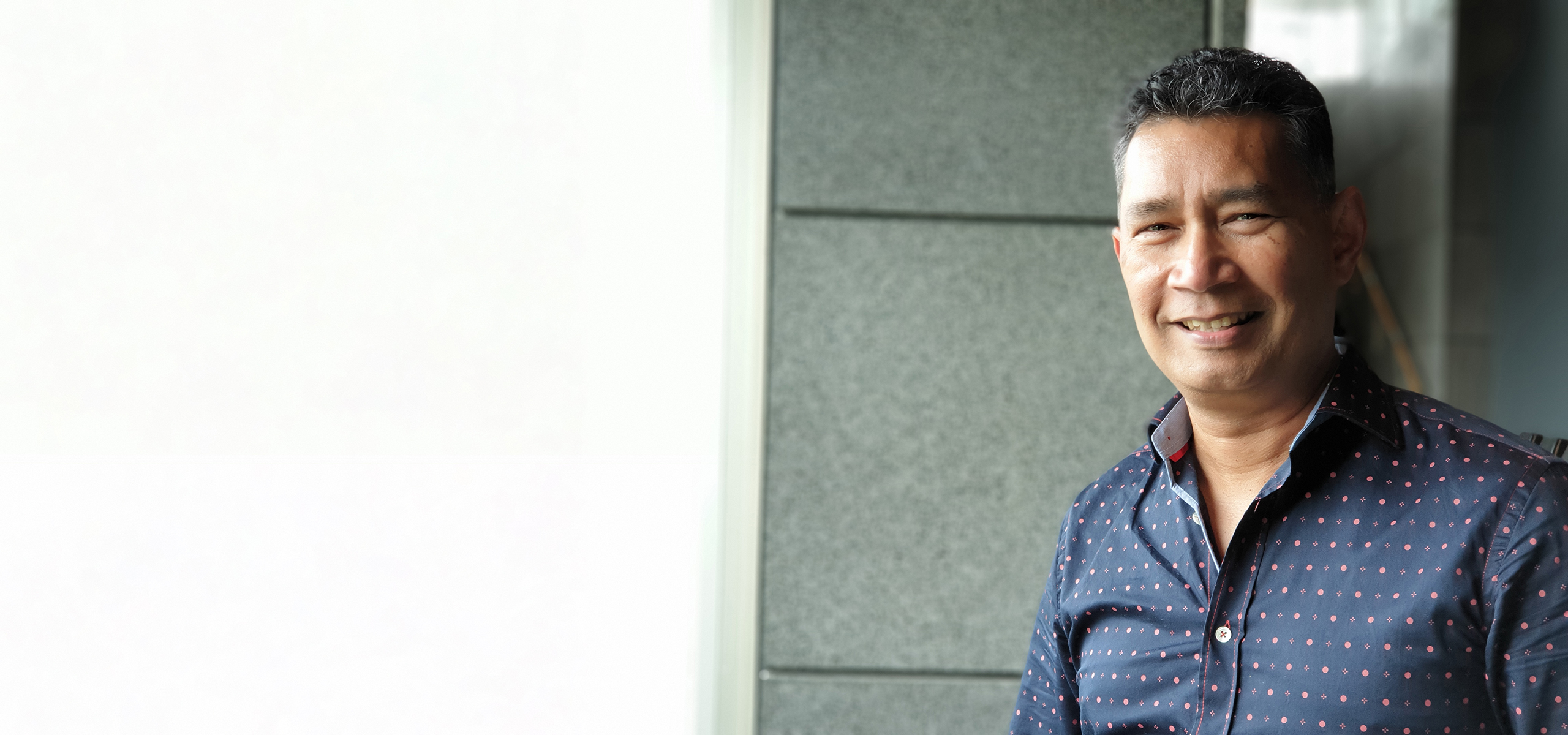 Rumi Shivaz standing outside a building